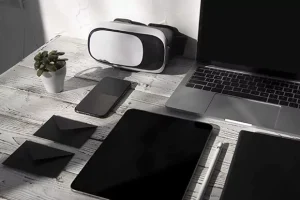 A collection of modern electronic devices on a wooden table.