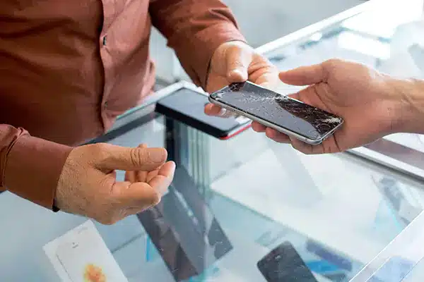 Technician receiving a broken phone from a customer